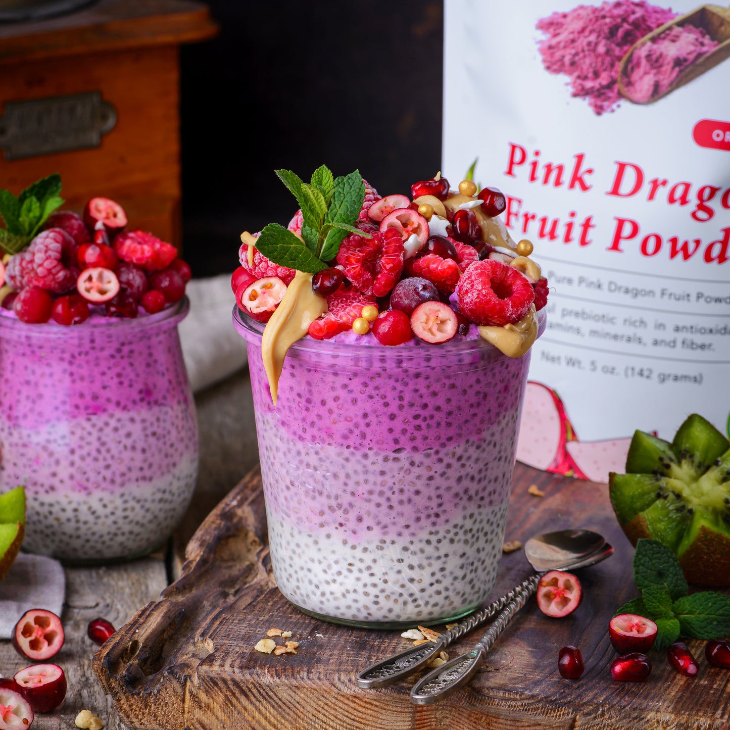 Pink chia pudding made with Ancient Choice dragon fruit powder, topped with berries, nut butter and mint