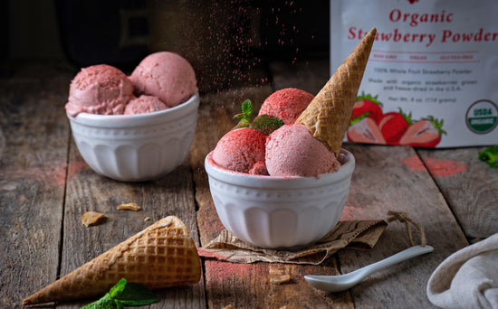 Two bowls of strawberry powder ice cream being dusted with strawberry powder