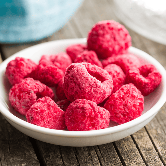  White bowl filled with freeze-dried raspberries.