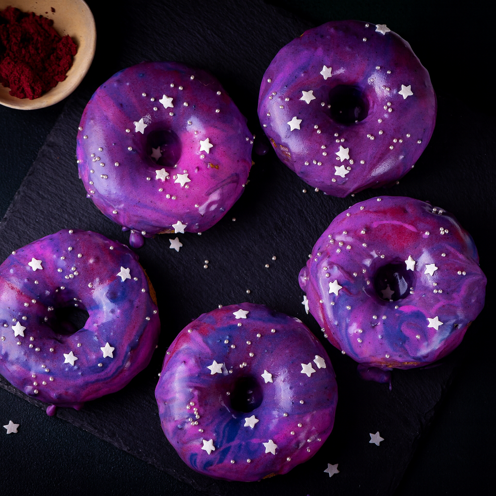 Galaxy donuts made with Ancient Choice Butterfly Pea Flower Powder, Wild Blueberry Powder, and Dragon Fruit Powder.